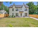 A modern home featuring a rear exterior with a well-maintained lawn and a gray trim at 2809 Glenwood Se Ave, Atlanta, GA 30317