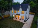 Stunning aerial view of a two-story home featuring modern design, landscaping, and a private driveway at 2809 Glenwood Se Ave, Atlanta, GA 30317