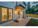 Inviting front porch with double glass doors and modern lighting, with a glimpse into the dining room at 2809 Glenwood Se Ave, Atlanta, GA 30317