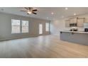 Open concept living area featuring wood-look flooring, and stainless steel appliances at 321 Heavenly Hollow Pl, Mcdonough, GA 30253
