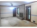 Cozy living room features a brick fireplace, ceiling fan, and an exit to the backyard at 4747 Darlene Way, Tucker, GA 30084