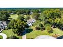 Aerial view of a beautiful house surrounded by mature trees and lush greenery at 160 Isleworth Way, Fayetteville, GA 30215