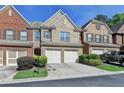 Charming townhome with brick facade, two-car garage, and well-maintained landscaping at 3351 Vintage Se Cir, Smyrna, GA 30080