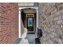 Close-up of a brick townhome entrance with a classic black front door and white trim at 3351 Vintage Se Cir, Smyrna, GA 30080