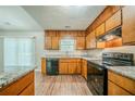 Bright kitchen featuring abundant counter space, wooden cabinetry, and stainless appliances at 1934 Patton Pl, Lithonia, GA 30058