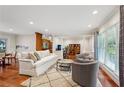 Bright living room featuring hardwood floors, modern furniture, and large windows providing ample natural light at 2624 Lake Erin Drive Dr, Tucker, GA 30084