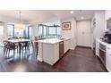 Open kitchen boasts stainless steel appliances, a breakfast bar, and sleek white cabinetry at 2795 Peachtree Ne Rd # 1009, Atlanta, GA 30305