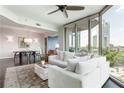 Inviting living room with comfortable seating, and views through the expansive windows and doors at 2795 Peachtree Ne Rd # 1009, Atlanta, GA 30305