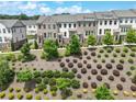 An aerial view of townhomes in a community featuring manicured landscaping at 416 Montclair Ct, Woodstock, GA 30188