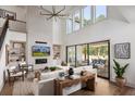 Inviting living room with a cozy fireplace, soaring ceilings, and large windows that offer great views at 6930 Pond View Dr, Cumming, GA 30028
