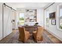 Bright office featuring built-in shelves, a barn door, and stylish decor, creating an ideal workspace at 6930 Pond View Dr, Cumming, GA 30028