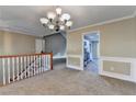 Open-concept area showcasing neutral paint, staircase, and an entry to the adjacent kitchen at 1400 Scenic Brook Sw Trl, Conyers, GA 30094