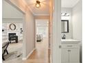 Bright hallway with light wood floors, a modern powder room, and access to the living area at 1911 Woodmont Ct, Marietta, GA 30062