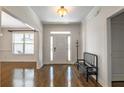 Inviting foyer with hardwood floors, crown molding, and a charming bench, leading into the home at 200 Glenview Ct, Woodstock, GA 30188