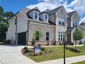Charming two-story house with a front-facing garage, landscaped yard, and a 'For Sale' sign at 2949 Longbush, Duluth, GA 30097