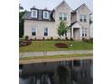 Classic two-story home with a light brick facade, large windows, and a green lawn at 2949 Longbush, Duluth, GA 30097