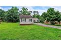 Spacious front yard with a single-story home and a long driveway at 3333 Old Salem Se Rd, Conyers, GA 30013