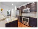 Modern kitchen with granite countertops, stainless steel appliances, dark wood cabinets, and subway tile backsplash at 1802 Dekalb Ne Ave, Atlanta, GA 30307