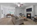 Open-concept living room with fireplace seamlessly connects to the dining area at 2735 Maple Park Pl # 32, Cumming, GA 30041