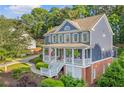 Two-story home with well-maintained landscaping, brick accents, and a spacious front porch at 321 River Green Ave, Canton, GA 30114