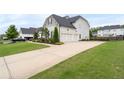 Spacious driveway leading to a well-maintained home with a three-car garage at 6840 Canyon Creek Way, Cumming, GA 30028