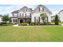 Beautiful home featuring manicured lawn, stone accents, and classic architectural details at 6840 Canyon Creek Way, Cumming, GA 30028