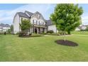 Well-maintained lawn and landscaping enhance this home's curb appeal at 6840 Canyon Creek Way, Cumming, GA 30028