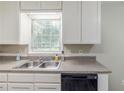 Stainless steel double sinks and black dishwasher below window in kitchen at 3120 Westwood Dr, Acworth, GA 30102