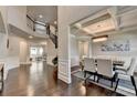 Open-concept foyer leading to dining room and staircase, with hardwood flooring throughout at 7470 Oldbury Pl, Cumming, GA 30040