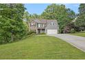 Beautiful home with stone and siding exterior, set on a well-manicured lawn with mature trees at 27 Rose Brooke Cir, White, GA 30184