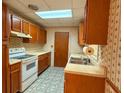 Functional kitchen with wooden cabinets, laminate countertops, double sink, and essential appliances for comfortable meal preparation at 7125 Chappell Cir, Atlanta, GA 30360