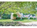 Charming single story home with brick and vinyl siding and a manicured lawn with mature trees at 1249 Scripps Sw Ct, Marietta, GA 30008