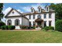Lovely two-story home with manicured lawn and charming front porch with wood columns at 2968 Ovalene Sw Ct, Marietta, GA 30064