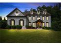 Stunning twilight view of a two-story home with a well-lit, manicured front lawn at 2968 Ovalene Sw Ct, Marietta, GA 30064