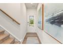 Inviting entryway with wood flooring, staircase, and natural light from the front door at 1882 Copelyn Reese Court (Lot 167), Lawrenceville, GA 30043