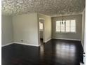 Inviting living room with wood floors and entry to the kitchen at 888 Beecher Sw Ct, Atlanta, GA 30311