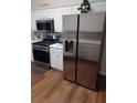 Modern kitchen with stainless steel appliances, including a refrigerator, range, and microwave at 257 Se Ashland Park Se Ct, Lawrenceville, GA 30045