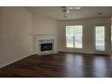 Comfortable living room featuring hardwood floors, a classic fireplace, and a large window at 257 Se Ashland Park Se Ct, Lawrenceville, GA 30045