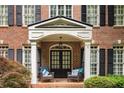 Close-up of a brick home's entry, showcasing a covered porch with chairs at 3227 Collier Gate Se Ct, Smyrna, GA 30080