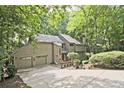 Traditional-style home featuring an attached two-car garage and ample driveway space at 4246 Loch Highland Ne Pkwy, Roswell, GA 30075