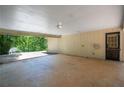 Inside view of the carport featuring a concrete slab, door entrance and access to the driveway at 5340 Young Deer Dr, Cumming, GA 30041