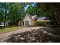 View of the home's exterior highlighting the attached carport and well-kept lawn at 5340 Young Deer Dr, Cumming, GA 30041