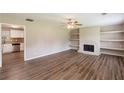 Open living room with fireplace and view into a well-appointed kitchen at 225 Fireside Way, Fairburn, GA 30213