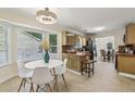 Eat-in kitchen showcasing a sunny breakfast nook with bay window, tile floors, and wood cabinetry at 255 Broken Lance Pl, Johns Creek, GA 30022