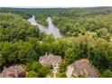 Breathtaking aerial view of the home nestled amidst lush greenery, showcasing its proximity to a serene river at 8470 Lazy Oaks Ct, Atlanta, GA 30350