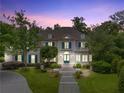 Charming two-story home with blue shutters, landscaped lawn, and a long driveway at 8470 Lazy Oaks Ct, Atlanta, GA 30350