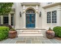 Close-up of the home's entry, boasting double doors and decorative planters at 8470 Lazy Oaks Ct, Atlanta, GA 30350