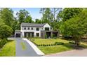 Beautiful two-story home boasts a manicured lawn, driveway, and lush greenery at 185 Pebble Trl, Alpharetta, GA 30009