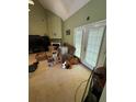 Bright living room with large French doors, fireplace, and neutral carpet at 384 Daniel Mill Xing, Villa Rica, GA 30180