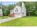 Two-story home with attached garage, green lawn, and mature trees at 2240 Creekside Vw, Decatur, GA 30035